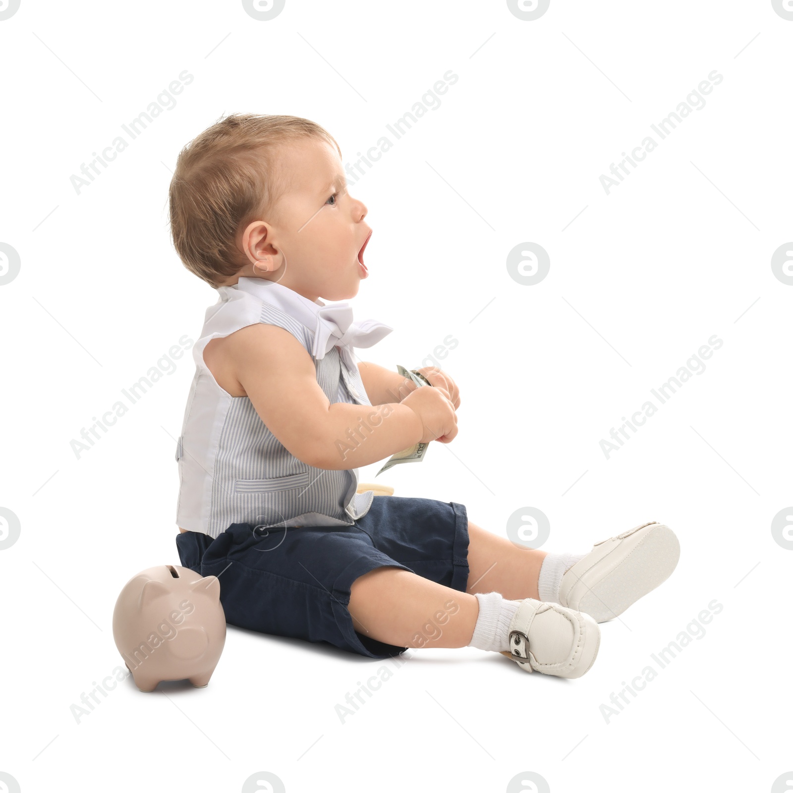 Photo of Little baby with money and piggybank on white background