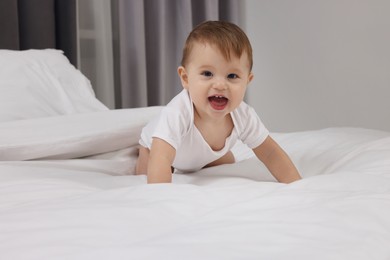 Photo of Funny little baby playing on bed at home