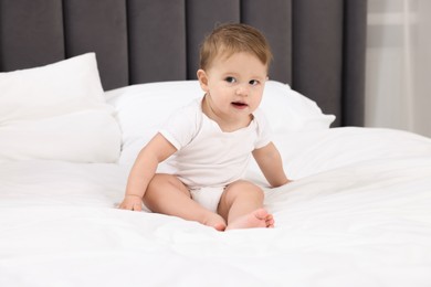 Photo of Cute little baby on bed at home