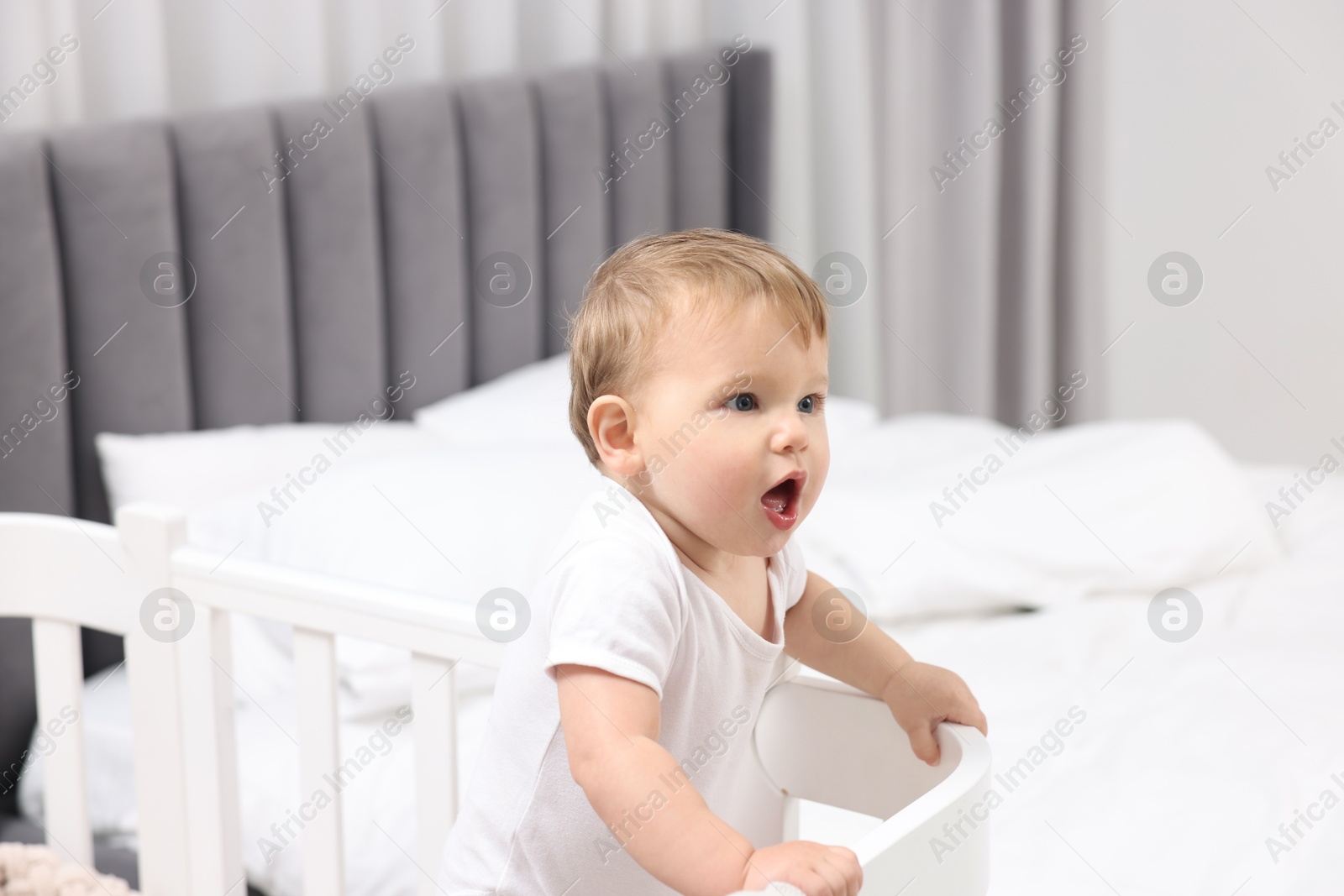 Photo of Cute little baby in crib at home