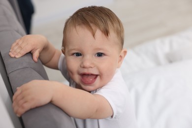 Photo of Cute little baby on bed at home