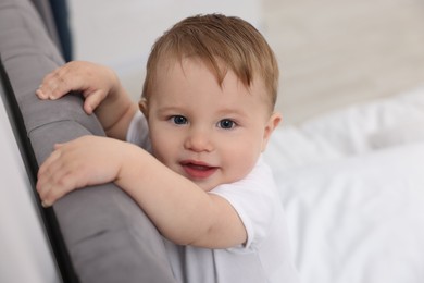 Photo of Cute little baby on bed at home