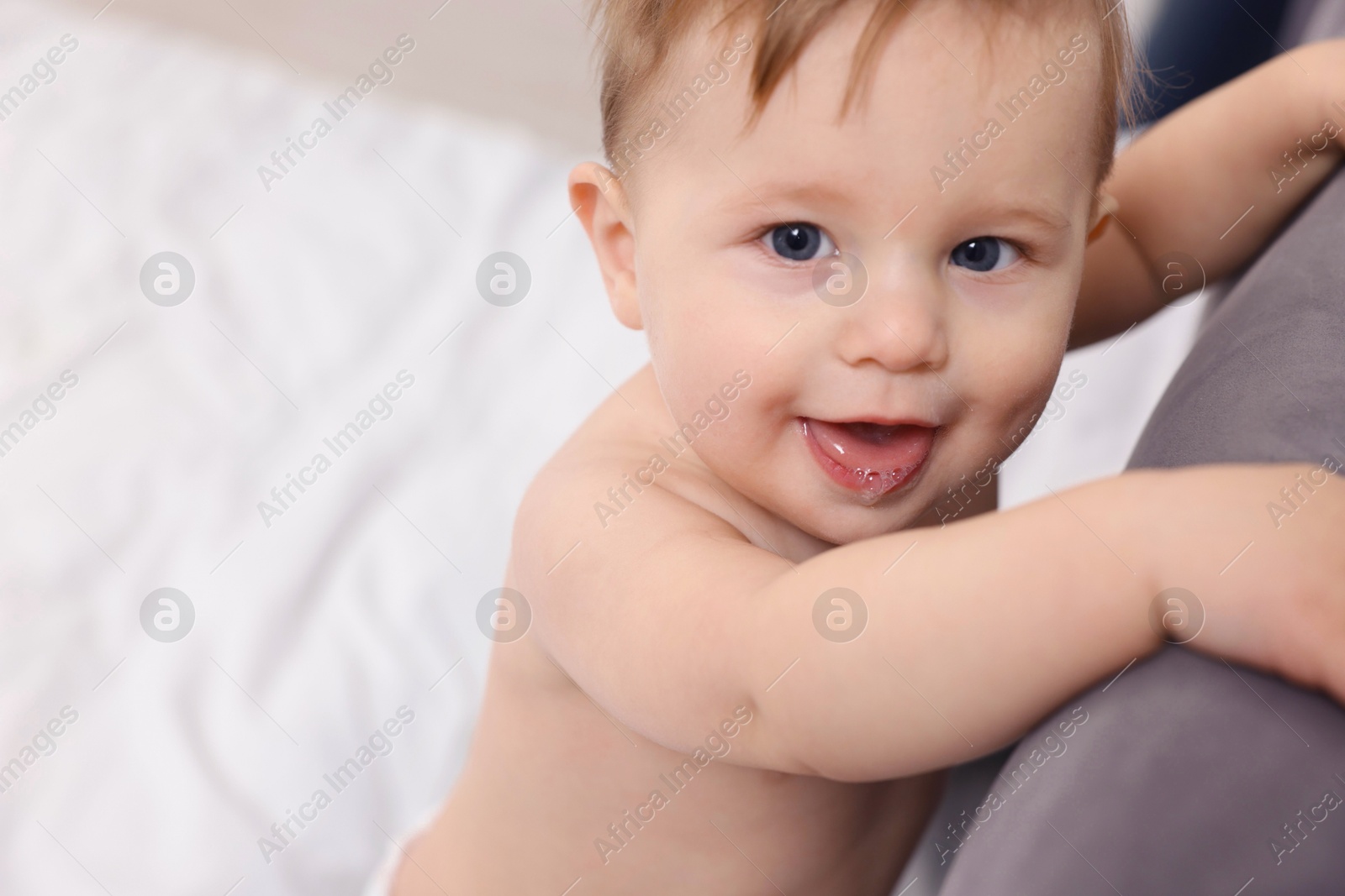 Photo of Cute little baby on bed at home. Space for text