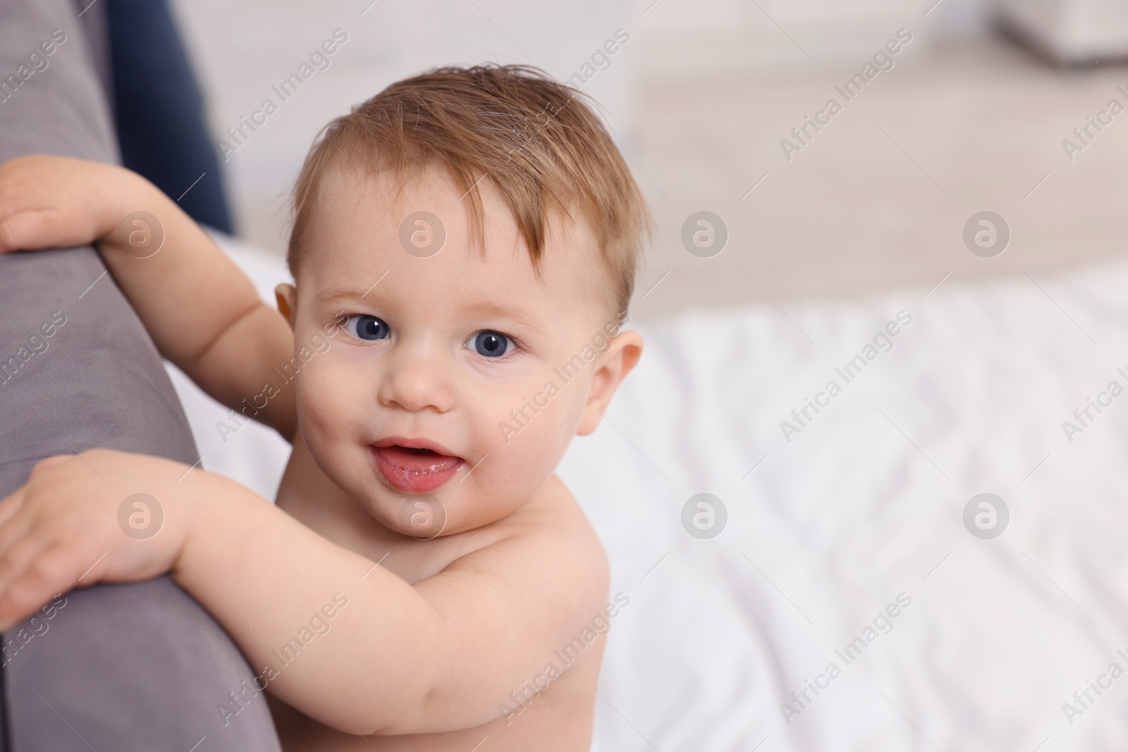 Photo of Cute little baby on bed at home. Space for text