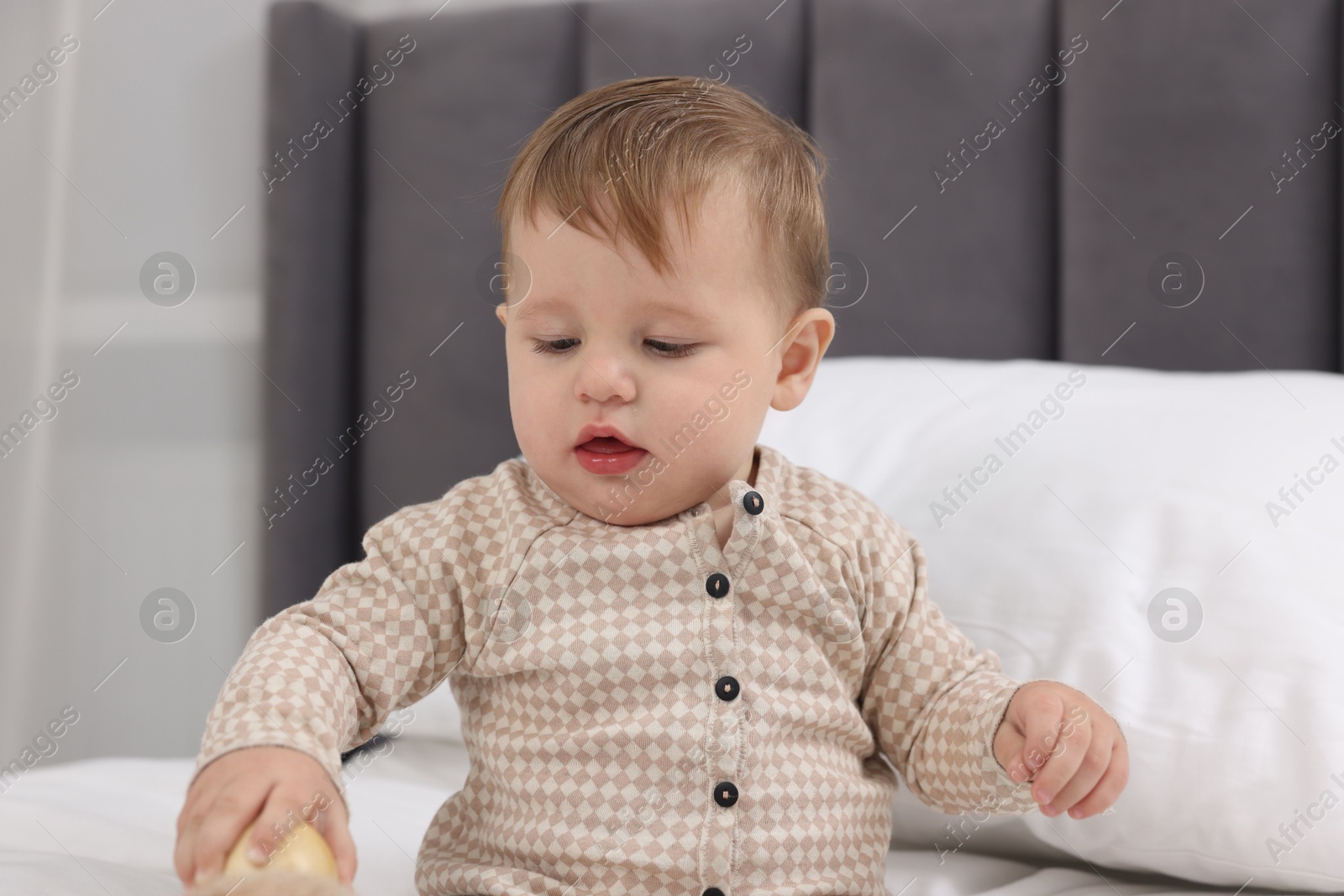 Photo of Cute little baby on bed at home