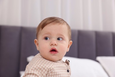 Photo of Cute little baby on bed at home