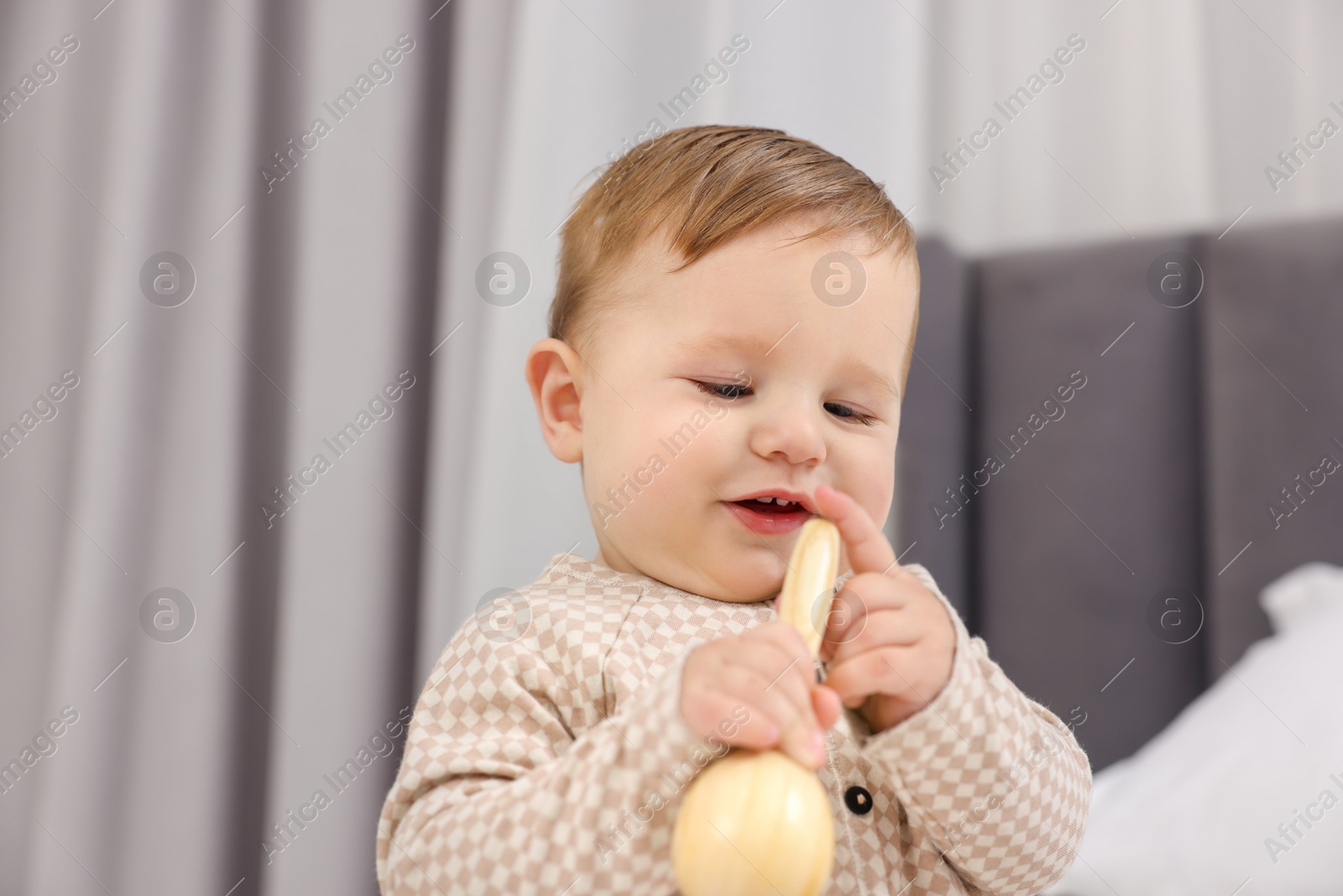 Photo of Adorable little baby with toy at home