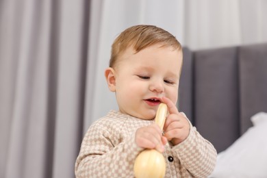 Photo of Adorable little baby with toy at home