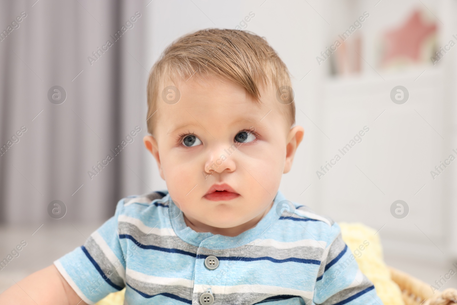 Photo of Cute baby boy in basket at home