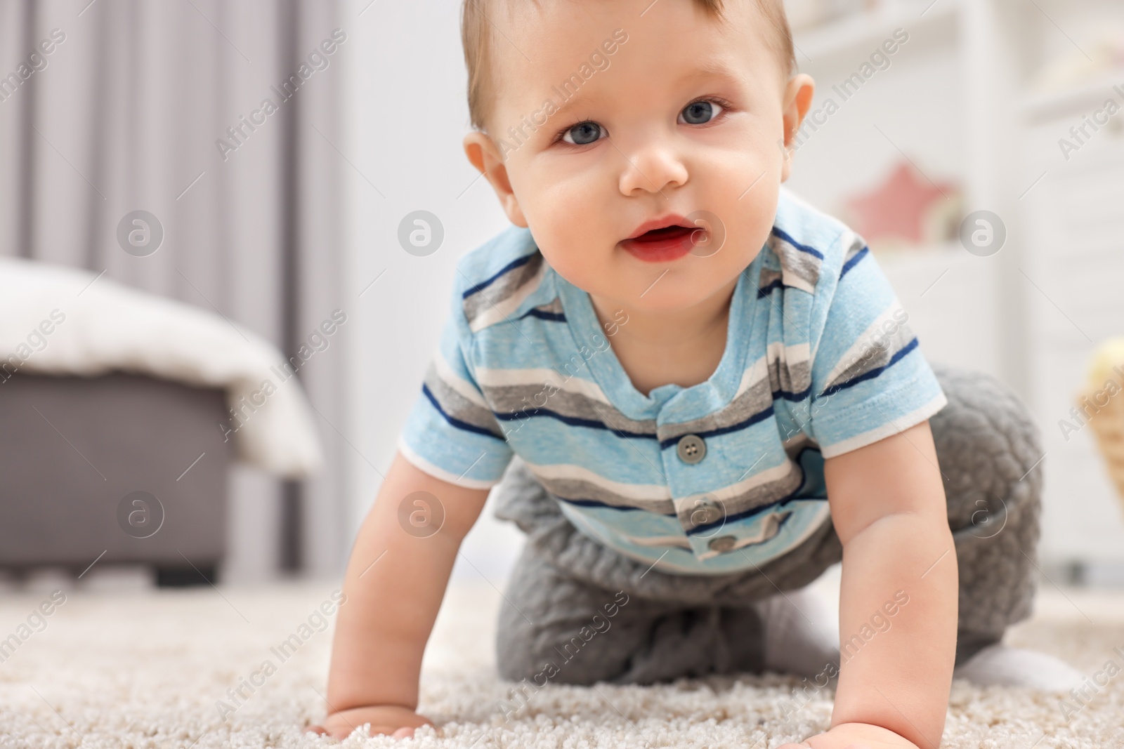 Photo of Adorable baby boy on floor at home