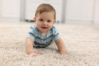 Photo of Adorable baby boy on floor at home