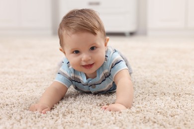 Photo of Adorable baby boy on floor at home