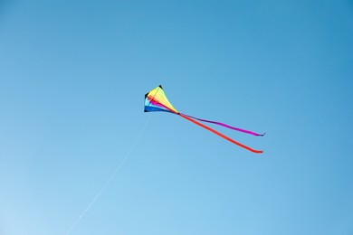 Photo of One colorful kite flying in blue sky