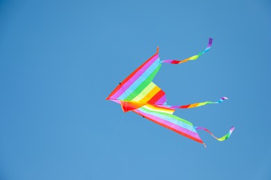 Photo of One colorful kite flying in blue sky