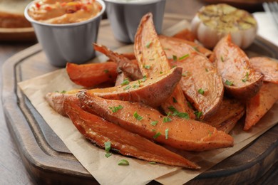 Photo of Tasty cooked sweet potatoes on table, closeup