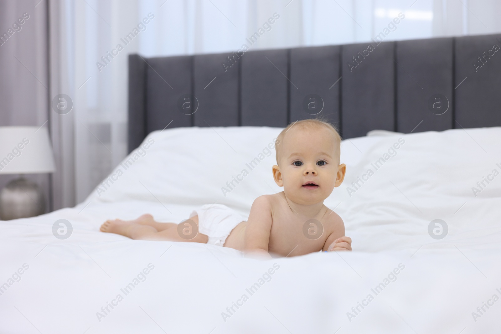 Photo of Cute little baby on bed at home