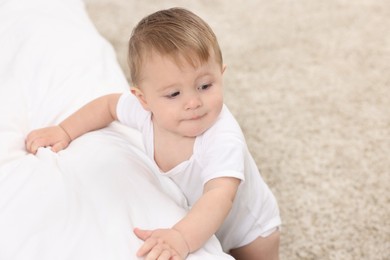 Photo of Sweet little baby near bed at home