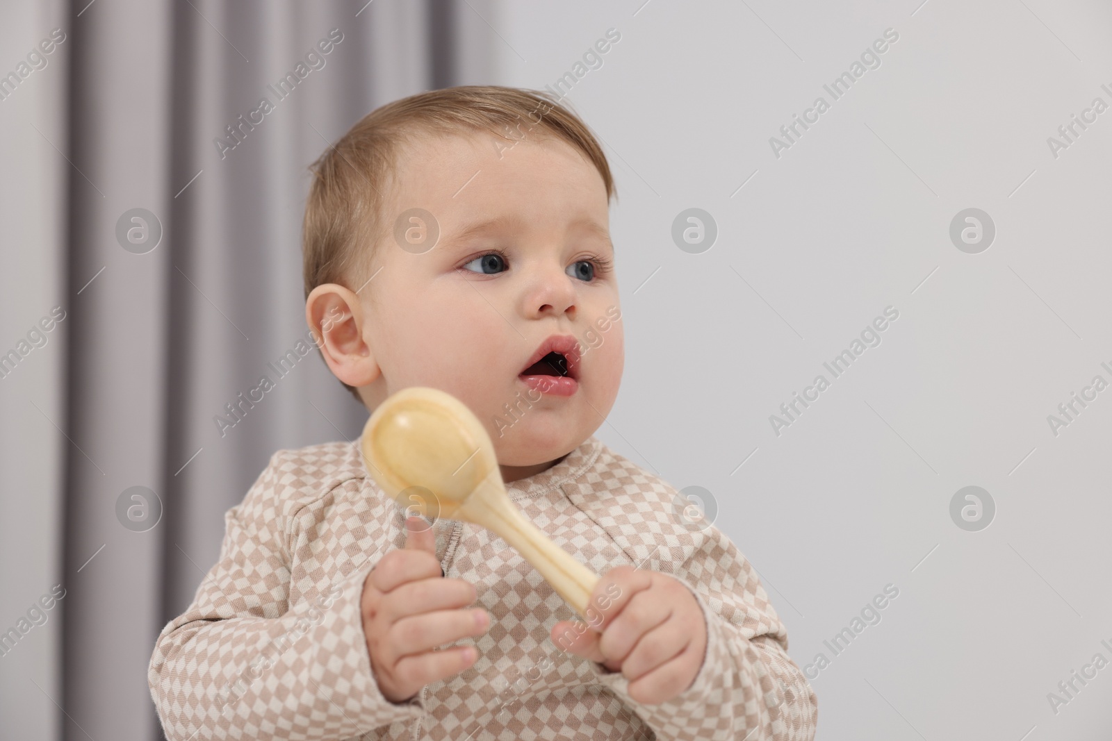 Photo of Adorable little baby with toy at home