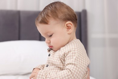 Photo of Sweet little baby on bed at home