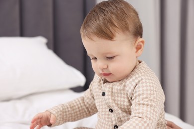 Photo of Cute little baby on bed at home