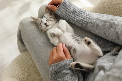 Photo of Woman with cute kitten at home, above view