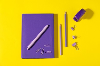 Photo of Different bright stationery on yellow background, flat lay