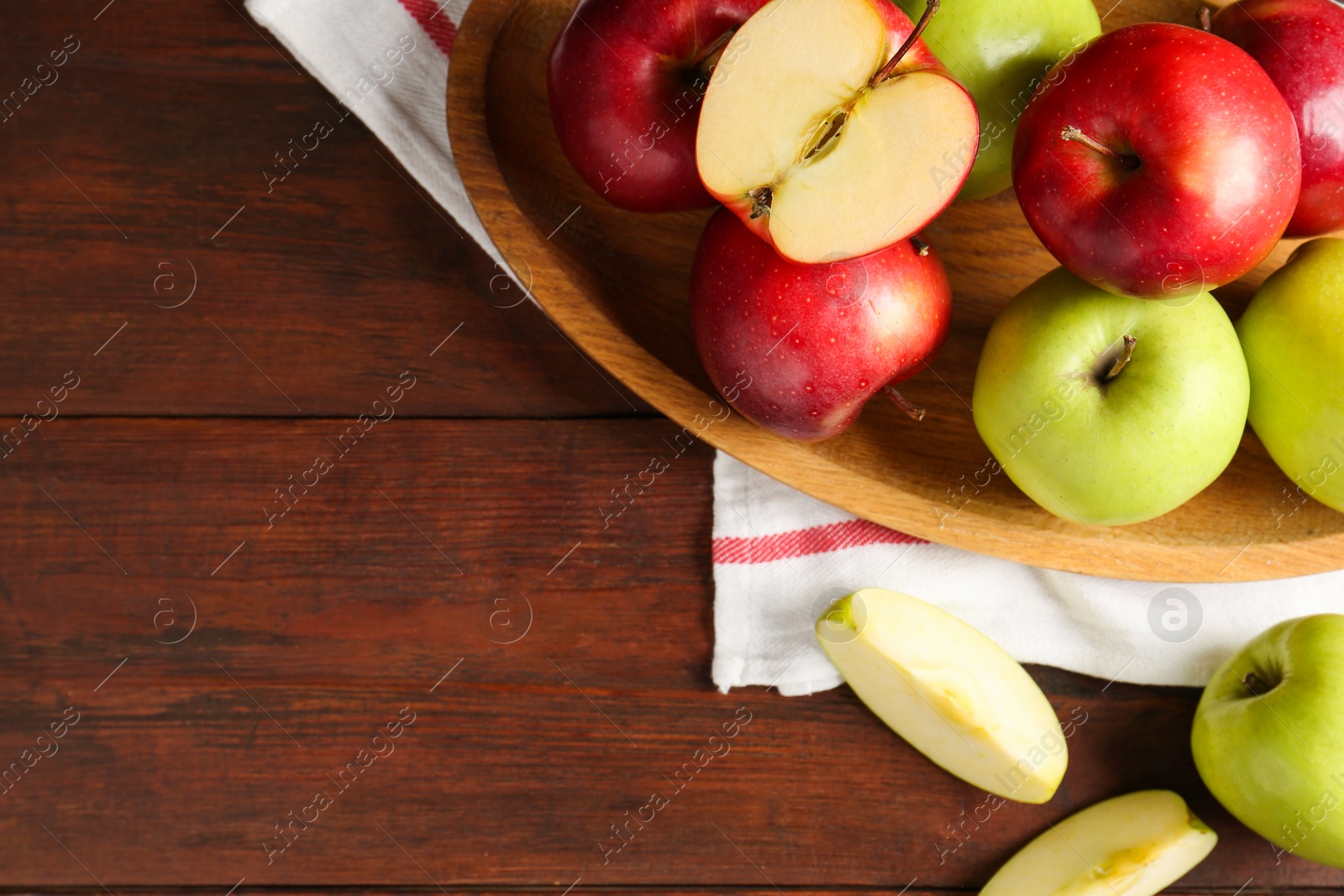 Photo of Fresh red and green apples on wooden table, flat lay. Space for text