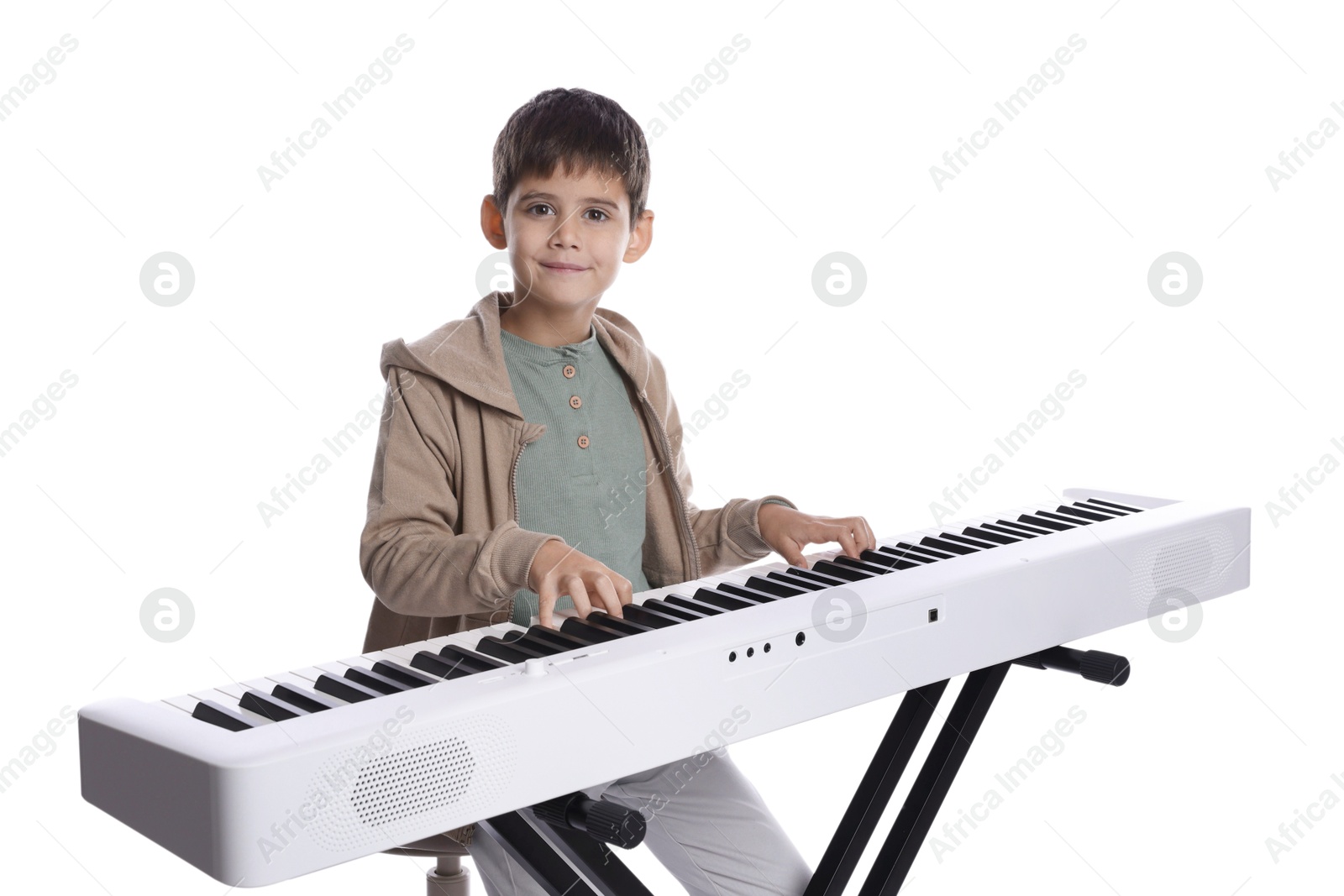 Photo of Cute boy playing synthesizer on white background