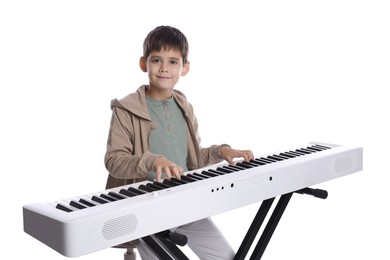 Photo of Cute boy playing synthesizer on white background