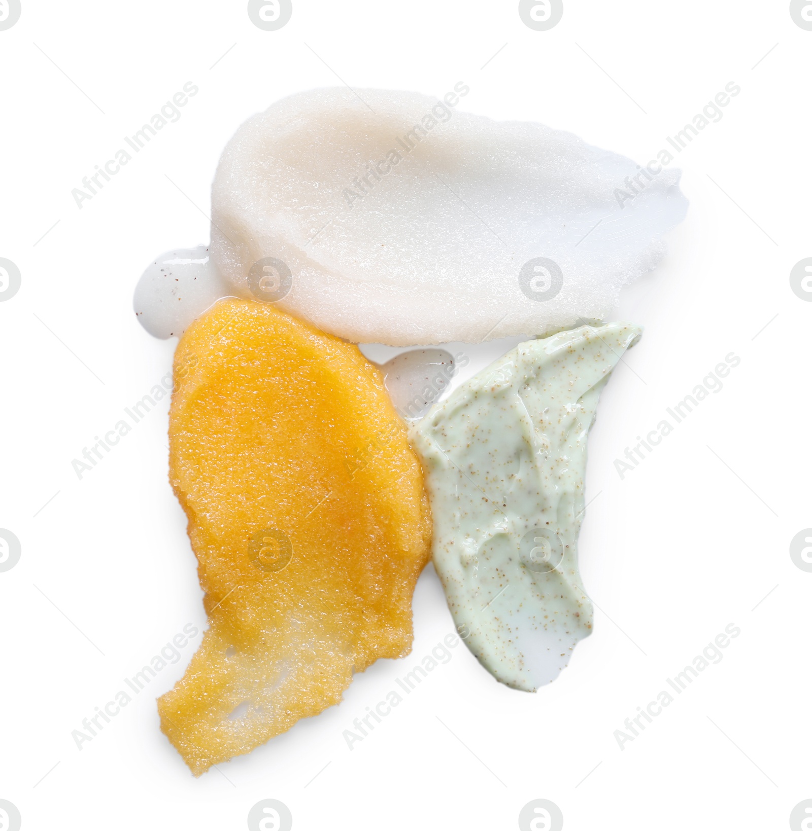 Photo of Smears of different body scrubs isolated on white, top view