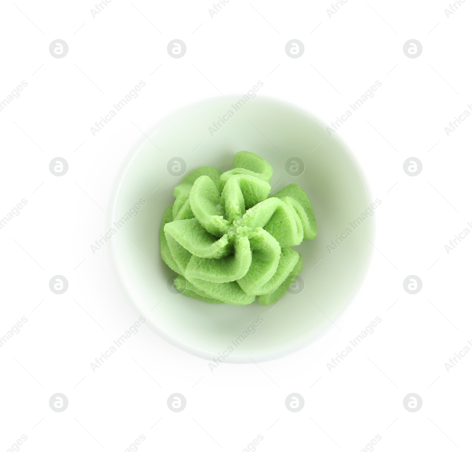 Photo of Hot wasabi paste in bowl isolated on white, top view