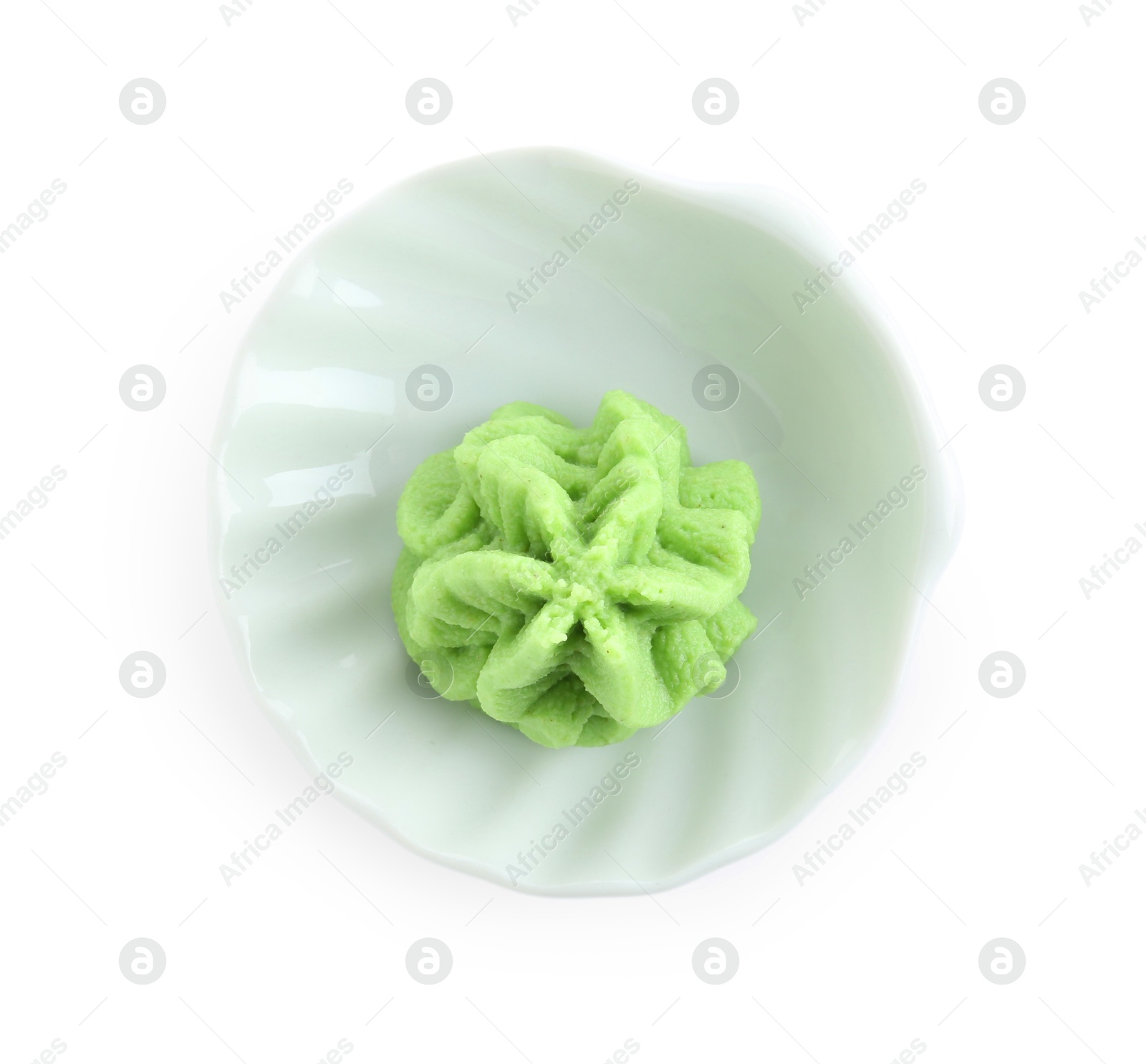 Photo of Hot wasabi paste in bowl isolated on white, top view