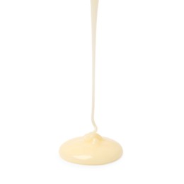 Photo of Pouring delicious condensed milk isolated on white