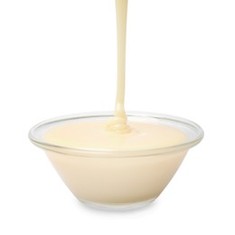 Photo of Pouring condensed milk into bowl isolated on white