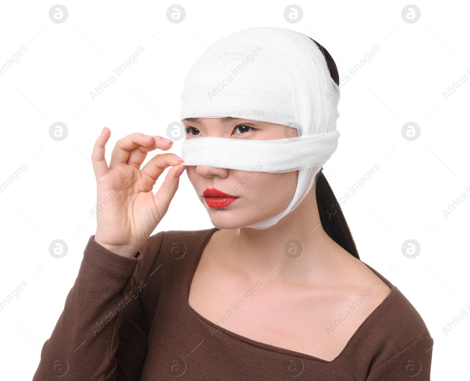 Photo of Woman with nose wrapped in medical bandage after plastic surgery operation on white background