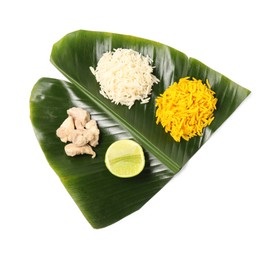 Cut banana leaf with different food isolated on white, top view. Healthy eco serving