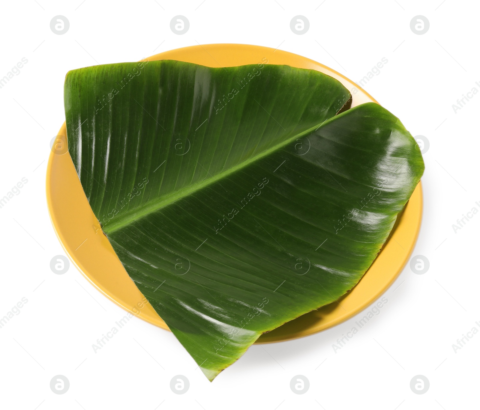 Photo of Plate with cut banana leaf isolated on white, above view. Healthy eco serving