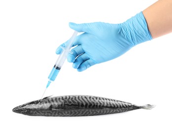 Photo of GMO concept. Scientist injecting something into fish on white background, closeup