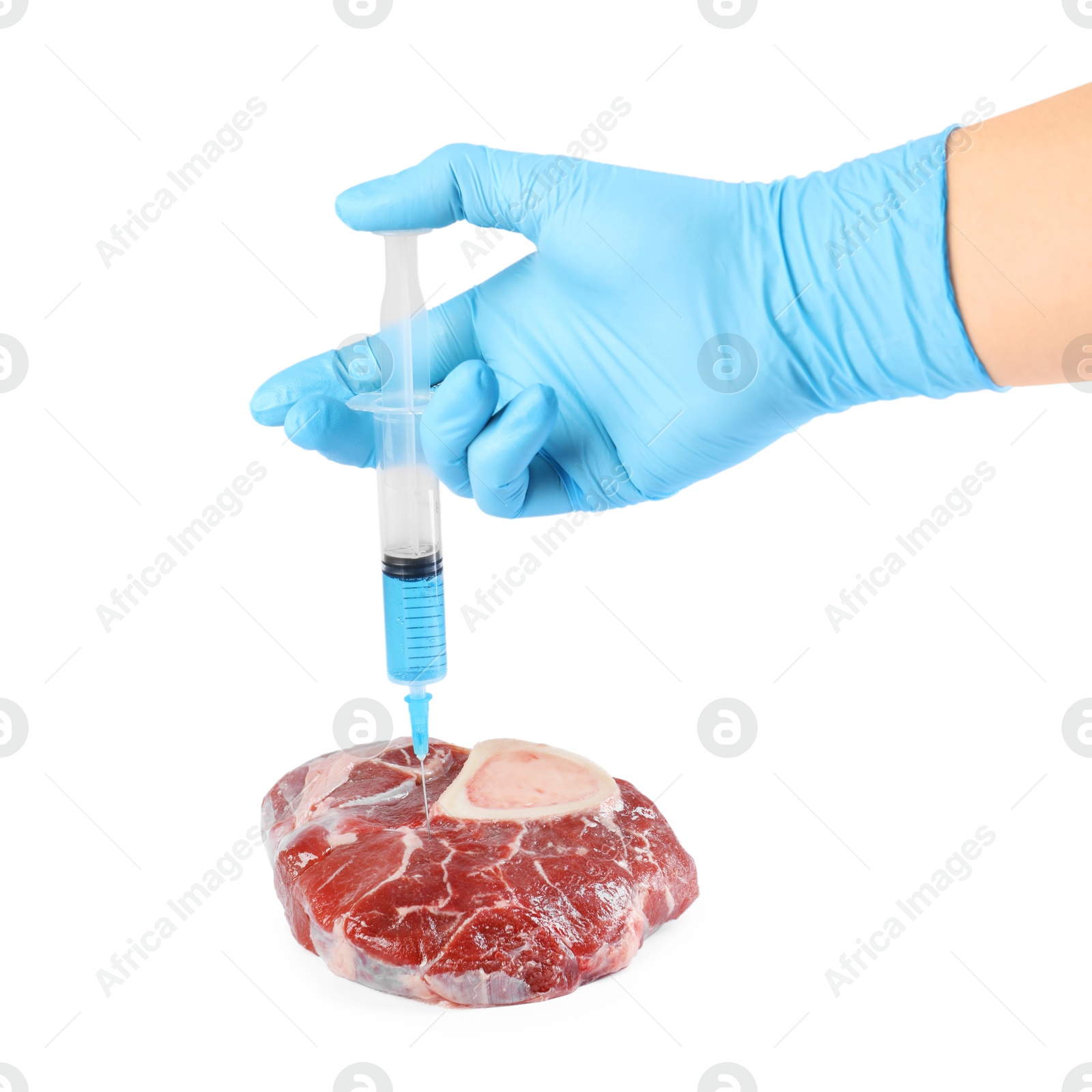 Photo of GMO concept. Scientist injecting something into piece of meat on white background, closeup