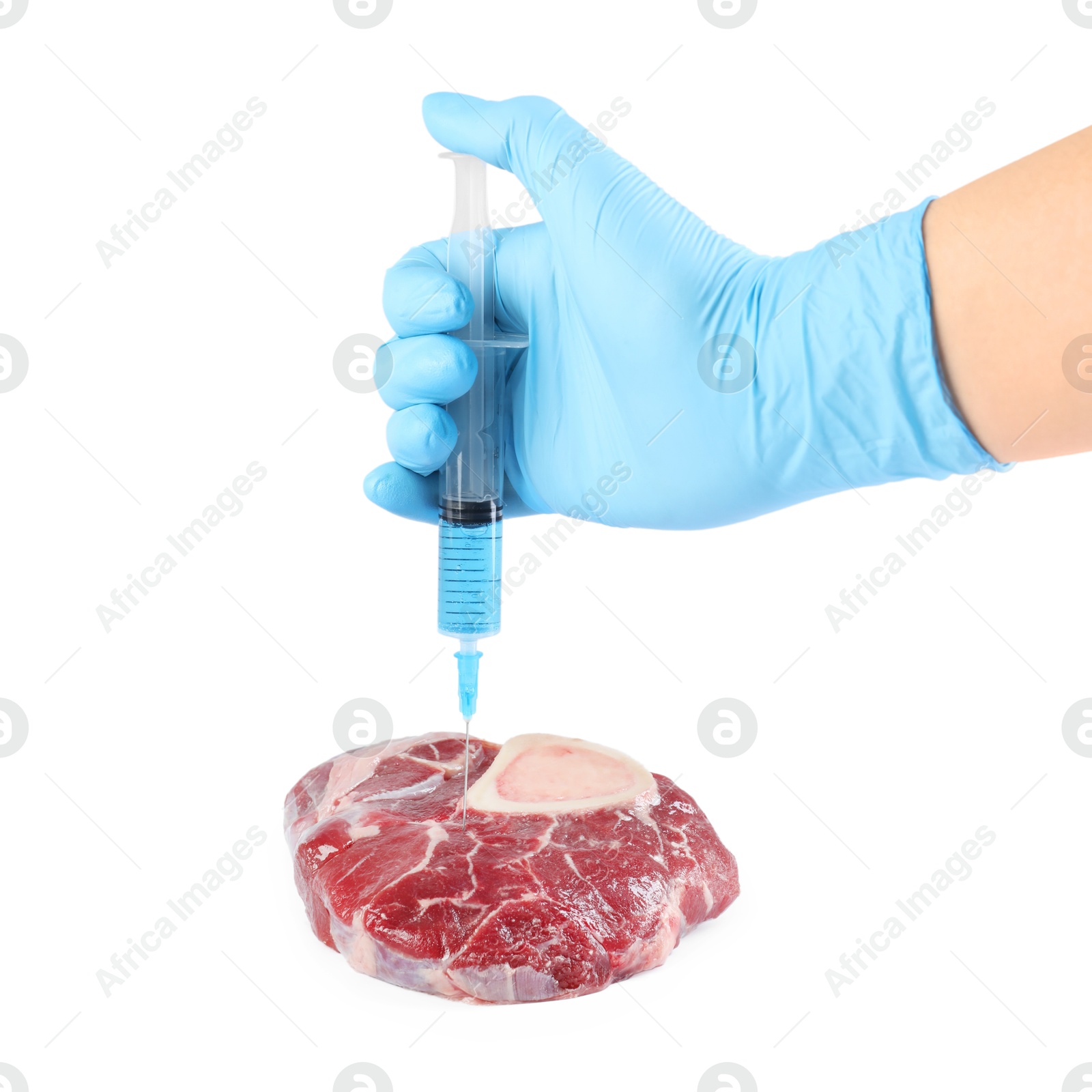 Photo of GMO concept. Scientist injecting something into piece of meat on white background, closeup