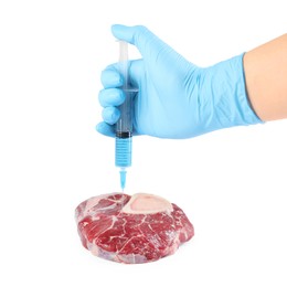 Photo of GMO concept. Scientist injecting something into piece of meat on white background, closeup