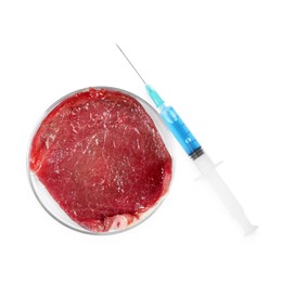 GMO concept. Piece of meat and syringe isolated on white, top view