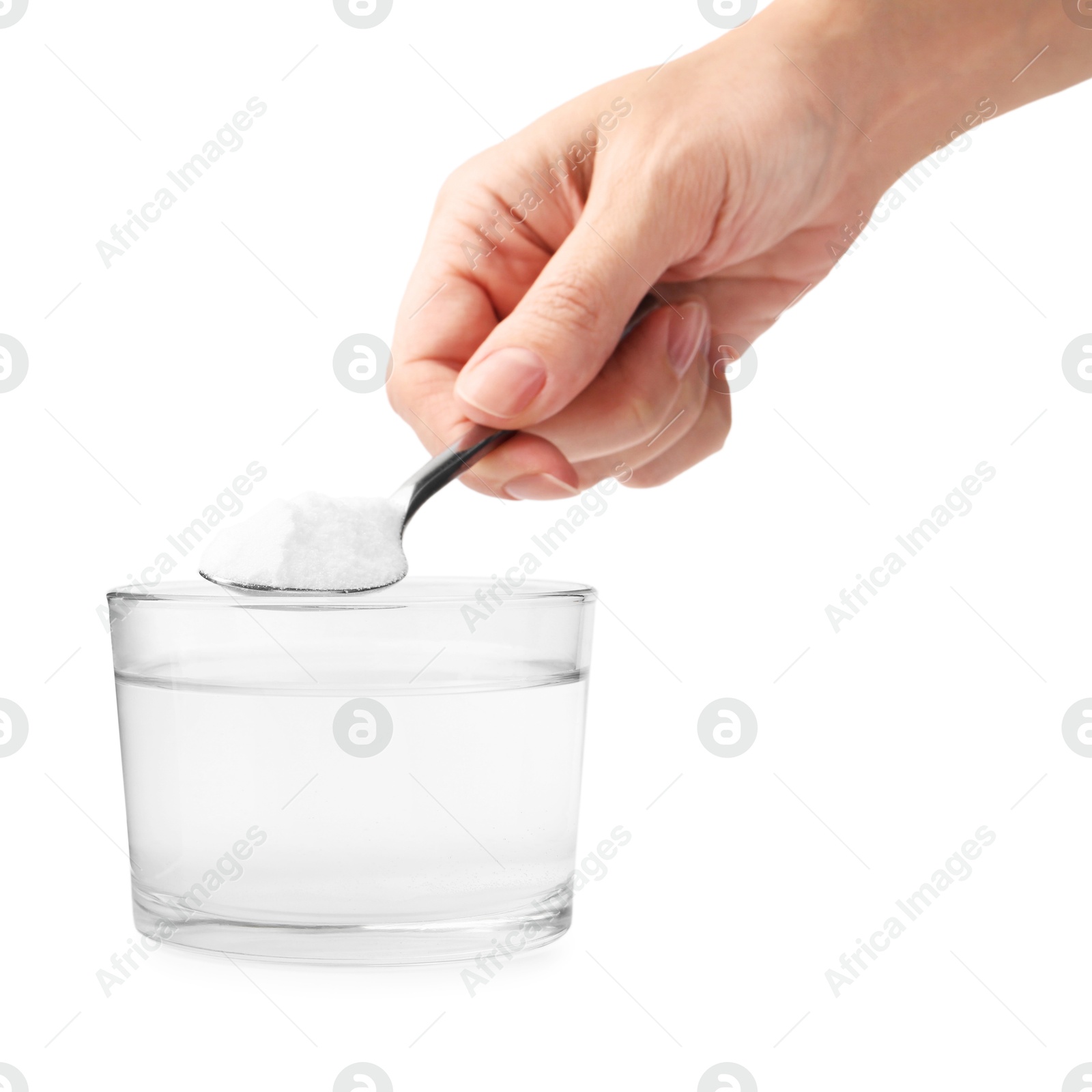 Photo of Woman adding baking soda to glass of water on white background, closeup