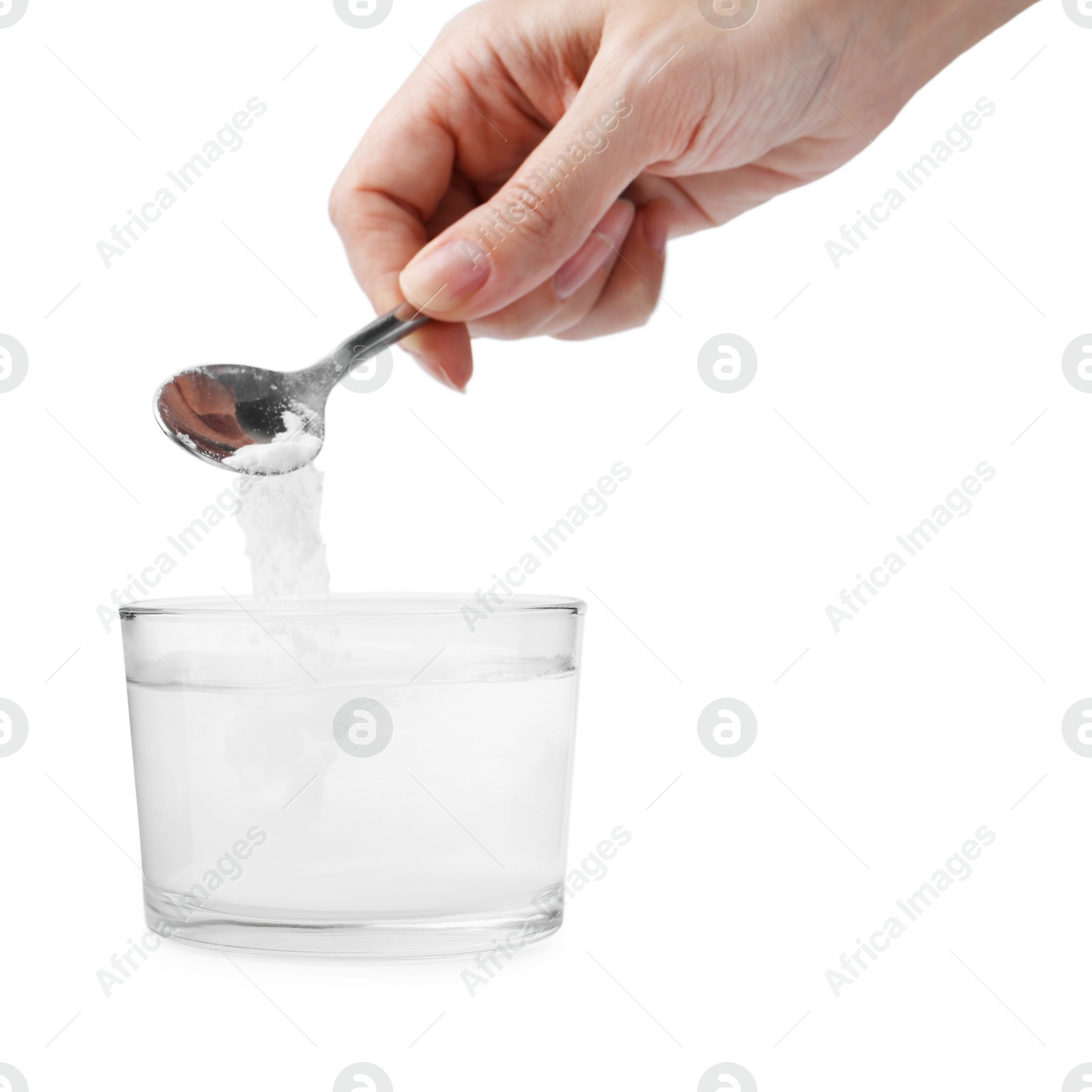 Photo of Woman adding baking soda to glass of water on white background, closeup