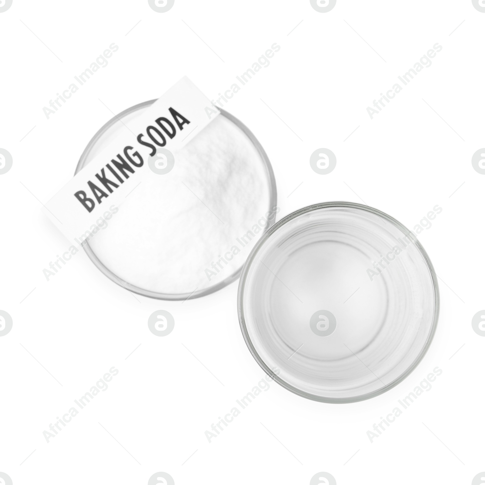 Photo of Glass of water and baking soda on white background, top view