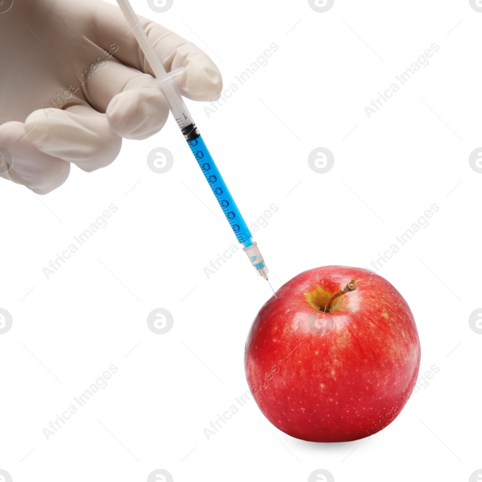 Photo of GMO concept. Scientist injecting something into fresh apple against white background, closeup