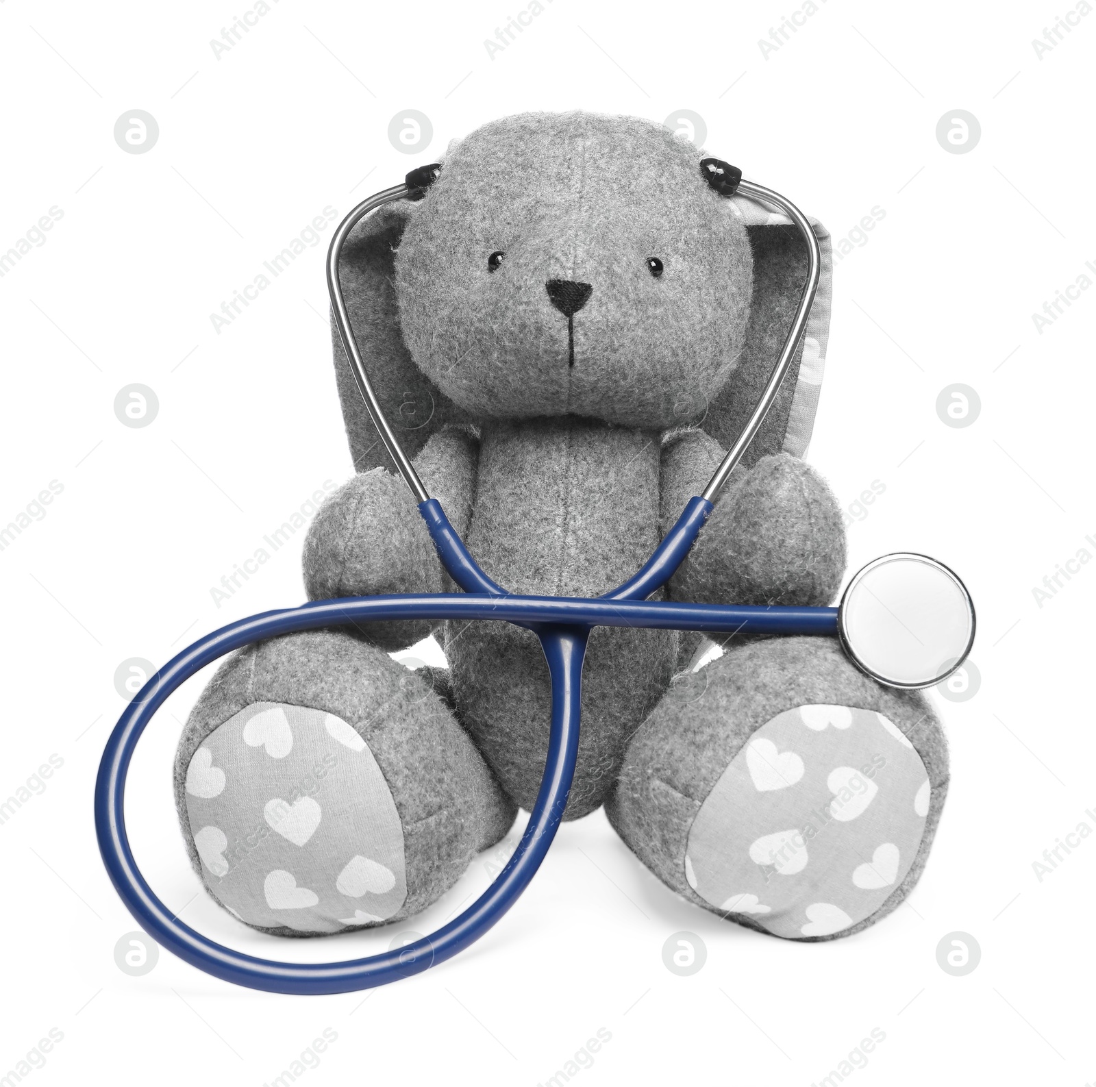 Photo of Pediatrics concept. Toy bunny with stethoscope isolated on white