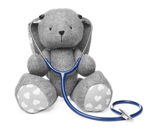 Photo of Pediatrics concept. Toy bunny with stethoscope isolated on white