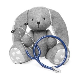 Photo of Pediatrics concept. Toy bunny with stethoscope isolated on white