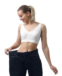 Photo of Weight loss. Happy woman wearing big jeans on white background